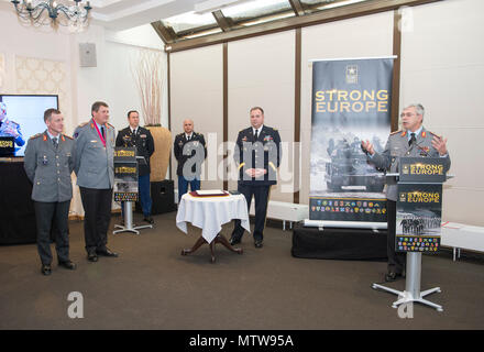 German Army Lt. Gen. Jörg Vollmer, Chief of Staff of the German Army (right) presents his remarks during the Patch Ceremony conducted by Lt. Gen. Ben Hodges, Commanding General of U.S. Army Europe (center) for the incoming U.S. Army Europe (USAREUR) Chief of Staff (CoS), German Army Brig. Gen. Kai Rohrschneider (left) and the outgoing USAREUR CoS, German Army Brig. Gen. Markus Laubenthal (second from left) on Lucius D. Clay Kaserne in Wiesbaden, Germany, Jan. 26, 2017. (U.S. Army Photo by Visual Information Specialist Volker Ramspott) Stock Photo