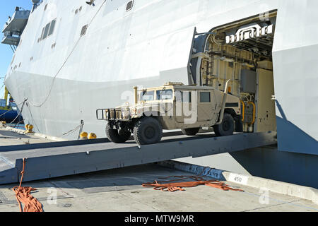 A Seabee drives a Humvee off the amphibious transport dock ship USS San ...