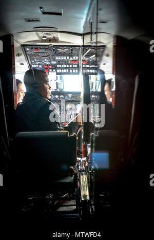 170130-F-WU507-002: Tech. Sgt. Vanessa Schook, 99th Airlift Squadron flight attendant, performs a pre-flight safety inspection on a C-20B at Joint Base Andrews, Maryland, Jan. 27, 2017. FAs are safety experts, customs specialists and culinary artists, often preparing meals from scratch at 30-to-40,000 feet, while ensuring the safety of the crew and passengers at all times. (U.S. Air Force photo by Senior Master Sgt. Kevin Wallace/RELEASED) Stock Photo