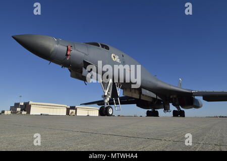 A B-1B Lancer of the 28th Bomb Squadron, 7th Operations Group, Dyess Air Force Base, Texas, sits near the historic hangar and Base Operations building while awaiting maintenance Jan. 27, 2017, at Tinker AFB, Oklahoma. 'Old Crow Express III' nose-art is clearly visible on the Air Force Global Strike Command bomber. (U.S. Air Force photo/Greg L. Davis) #Tinker75 Stock Photo