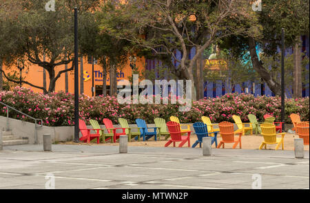 San José, California, USA - May 28, 2018: Colorful Adirondack chairs at Plaza de Cesar Chavez Park, with a view of the Tech Museum, in Downtown San Jo Stock Photo