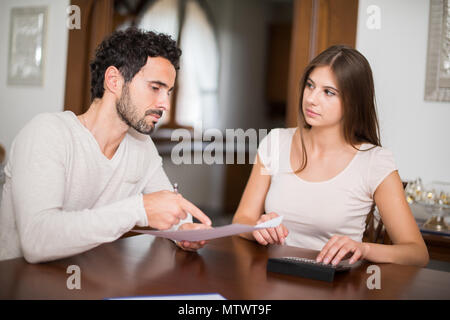 Couple calculating their expenses together Stock Photo