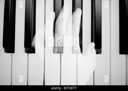 Close of hands plays melody on piano. Mobile photo. Stock Photo