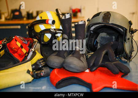 This photo shows the gear Coast Guard aviation survival technicians need to wear when jumping into the winter water while at Air Station Cape Cod in Massachusetts on Jan. 19, 2017. ASTs work out five days a week in order to stay in top physical form to perform their job. (U.S. Coast Guard photo by Petty Officer 3rd Class Nicole J. Groll)