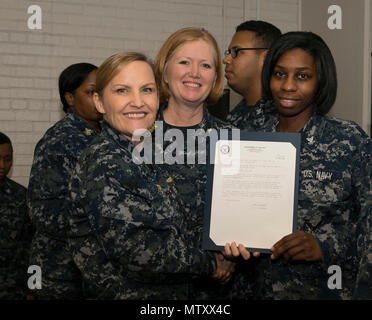 NEWPORT NEWS, Va. (Jan. 04, 2017) – Ship’s Serviceman 2rd Class Yolonda Butler, assigned to Pre-Commissioning Unit Gerald R. Ford (CVN 78), receives her frocking letter from Cmdr. Julie Treanor, Ford’s supply officer, and Ford’s command master chief Laura Nunley during a supply department frocking ceremony at Apprenticeship Hall.  More than 170 Ford Sailors advanced from the September Navy-wide advancement exam. (U.S. Navy photo by Mass Communication Specialist Seaman Joshua Murray) Stock Photo