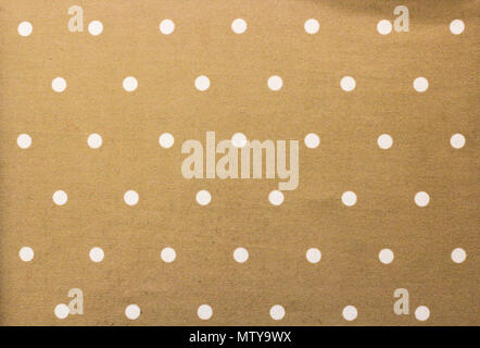 Golden fabric and a white tiny polka dots background Stock Photo