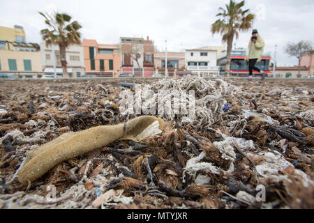 20 March 2018, Spain, Mallorca: Rubbish, mixed with sanitary products, lying on a beach in Palma bay. Sewage works in Palma quickly become overburdened when it rains and raw sewage ends up flowing directly into the sea. The rubbish then lands on the beaches and mixes with the Neptune grass in the sand. Photo: Bodo Marks/dpa Stock Photo
