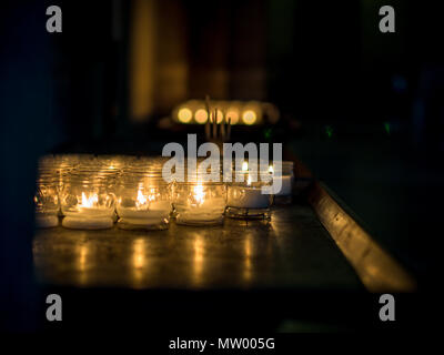 Tea light candles in a church, Basilica of Sant'Ambrogio, Milan, Lombardy, Italy Stock Photo