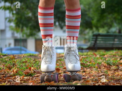 Close-up of a girl's legs wearing roller skates and long socks