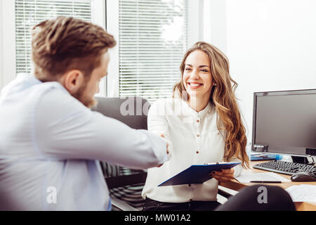 Businesspeople handshaking after negotiation or interview at office Stock Photo