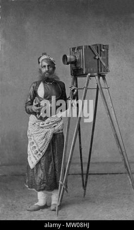 . English: Portrait of Mohan Lal with His Camera Date:   ca. 1875 Culture:   India (Udaipur, Mewar, Rajasthan) Medium:   Albumen print Dimensions:   Overall: 3 7/8 x 2 5/16 in. (9.8 x 5.8 cm) Mount: 4 1/8 x 2 1/2 in. (10.4 x 6.3 cm) Classification:   Photograph Credit Line:   Lent by Maharana of Mewar Charitable Foundation, The City Palace Complex, Udaipur Accession Number: SL.17.2011.22.9 . circa 1875. Unknown 496 Portrait of Mohan Lal with His Camera Stock Photo