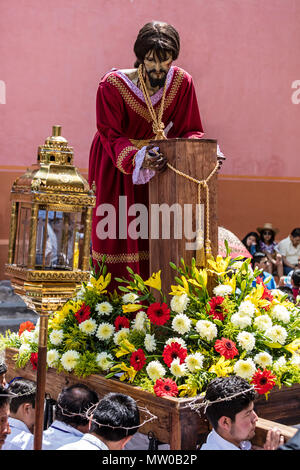 A statue of of JESUS on the pillar is carried down the steps of the SAN RAFAEL chapel during the Good Friday Procession called Santo Encuentro - SAN M Stock Photo