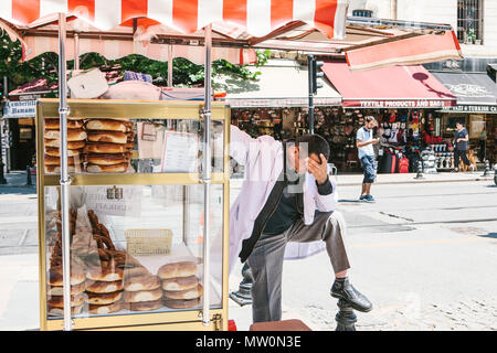 Editorial image of stressed out and upset street bakery product vendor having bad headache in Istanbul on June 15 2017. Stock Photo