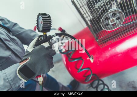 Garage Air Compressor. Adjusting Pressure in a Car Tires. Stock Photo