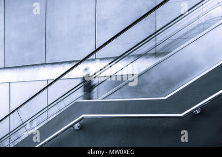 Blurred motion of one person on escalator with copy space Stock Photo