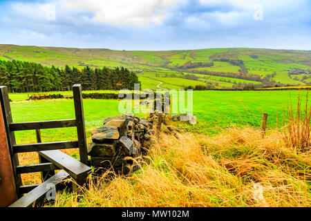 A stile on the rolling green walking hills of Derbyshire Stock Photo