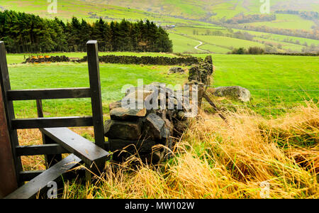 A stile on the rolling green walking hills of Derbyshire Stock Photo