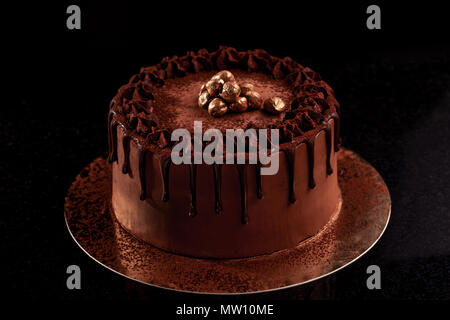 Chocolate cake with nuts on a black background Stock Photo