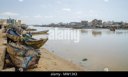 St Louis, Senegal - October 12, 2014: Colorful painted wooden fishing boats or pirogues at coast of St. Louis. Stock Photo