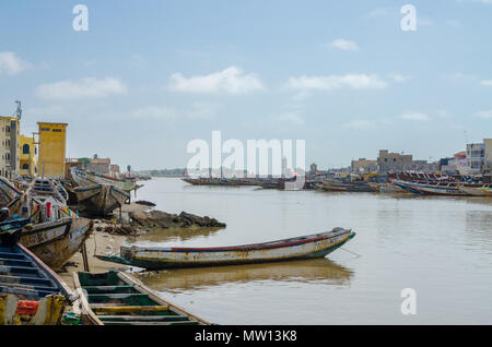 St Louis, Senegal - October 12, 2014: Colorful painted wooden fishing boats or pirogues at coast of St. Louis. Stock Photo