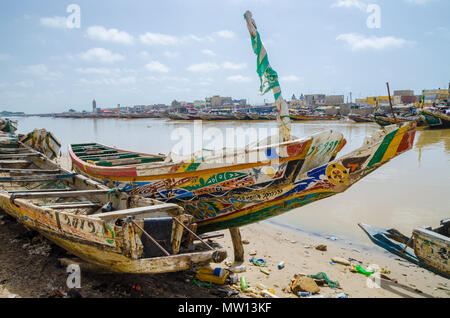 St Louis, Senegal - October 12, 2014: Colorful painted wooden fishing boats or pirogues at coast of St. Louis. Stock Photo