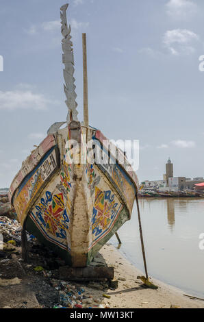 St Louis, Senegal - October 12, 2014: Colorful painted wooden fishing boats or pirogues at coast of St. Louis. Stock Photo