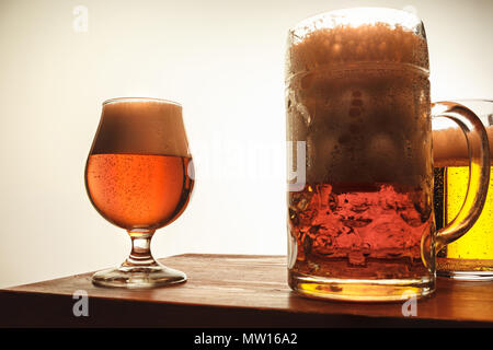 The two mugs of beer on table background Stock Photo