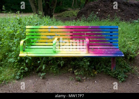 A rainbow coloured bench called Gradient Fade by Adham Faramawy in Tower Hamlets Cemetery Park Stock Photo