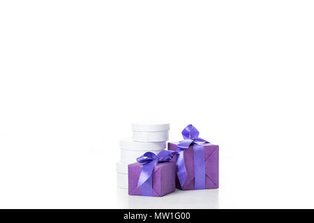 close up view of arrangement of various wrapped white and purple gifts isolated on white Stock Photo