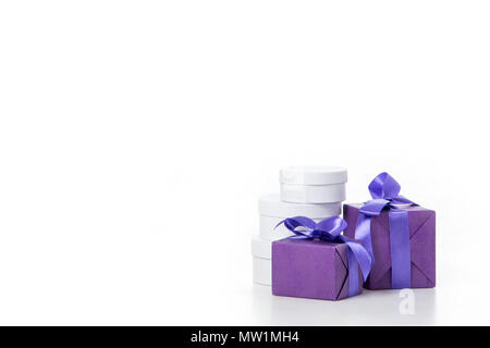 close up view of arrangement of various wrapped white and purple gifts isolated on white Stock Photo