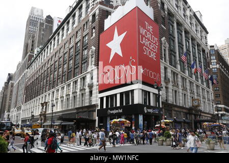 People cross Broadway and 34th Street by the Macy's flagship store in Manhattan. Stock Photo