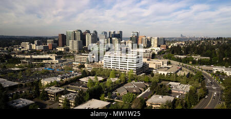 The bustling city of Bellevue Washington in early morning light with Seattle peaking out far in the background Stock Photo