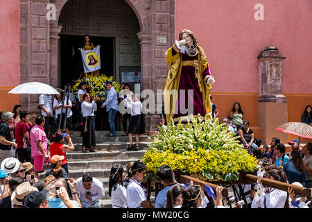 A statue of a MARY MAGDALENE is carried down the steps of the SAN RAFAEL chapel during the Good Friday Procession called Santo Encuentro - SAN MIGUEL  Stock Photo