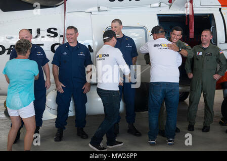 People rescued April 15 by the Coast Guard reunite with their rescuers at Air Station Clearwater, Florida, Thursday, April 27, 2017. Coast Guard members from the air station, Station Yankeetown and Sector St. Petersburg attended the reunion and recounted their April 15 rescue that saved five lives. Stock Photo