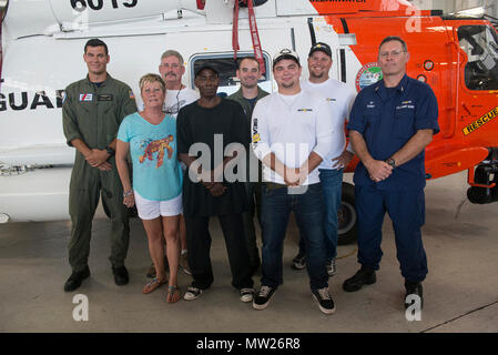 People rescued April 15 by the Coast Guard reunite with their rescuers at Air Station Clearwater, Florida, Thursday, April 27, 2017. Coast Guard members from the air station, Station Yankeetown and Sector St. Petersburg recounted their April 15 rescue that saved five lives. Stock Photo