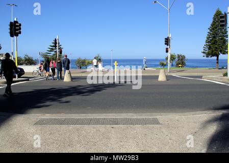 People crossing street at traffic intersection in Sydney. Pedestrians crossing road in Australia. Stock Photo