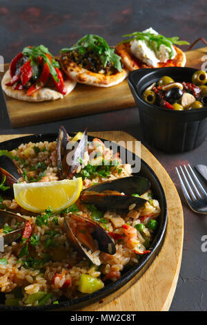 Set of tapas and paella with shrimps and mussels Stock Photo