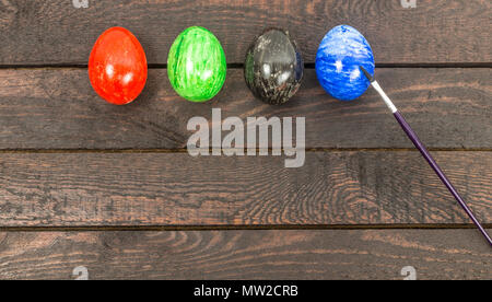 colouring eggs with brush for eastertime at home. Stock Photo
