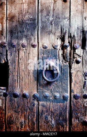 Old door handle background.Wood and metal aged doorknob.Ancient door detail Stock Photo