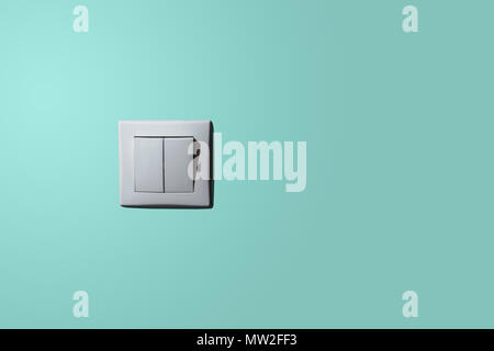 White light switch on a pastel background. The concept of electrical wholesalers, stores with electronic accessories. Minimalism. On the blue. Stock Photo