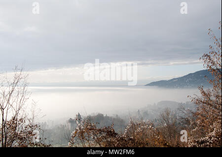 Low cloud blankets town in the alpine valley below. Views over Vevey, Lake Leman, Geneva area, Switzerland Stock Photo