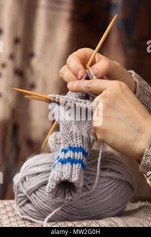 closeup of knitting a sock with bamboo needles Stock Photo