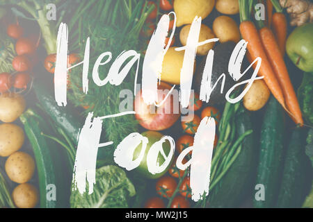 Crop view from above of fresh fruits and vegetables background with stylish inscription healthy food Stock Photo