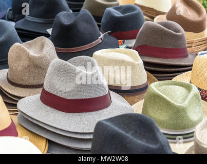 Many hats for men in different shapes and colors in one display for sale, germany Stock Photo