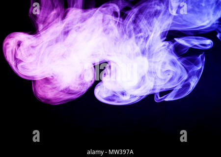 Colorful purple smoke  on a black isolated background. Background from the smoke of vape Stock Photo