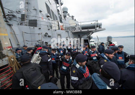 United Kingdom (April 27, 2017) Royal Navy flag officer sea training instructors and U.S. Navy Afloat Training Group Sailors prepare to disembark the Arleigh Burke-class guided-missile destroyer USS Carney (DDG 64) in Plymouth, United Kingdom. Carney is forward-deployed to Rota, Spain, conducting its third patrol in the U.S. 6th Fleet area of operations in support of U.S. national security interests in Europe. Stock Photo