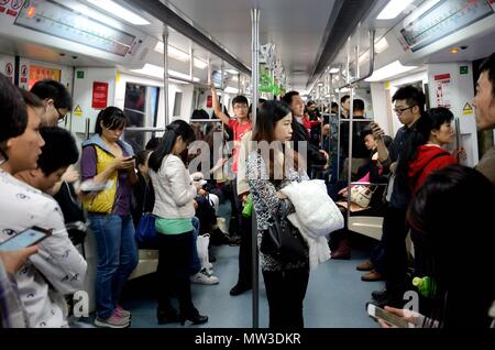 SHENZHEN, CHINA - APRIL 3: Inside metro train. Most people busy with their smartphones on April 3rd, 2018. Stock Photo
