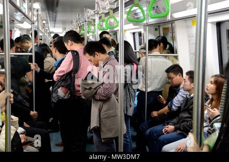SHENZHEN, CHINA - APRIL 3: Inside metro train. Most people busy with their smartphones on April 3rd, 2018. Stock Photo