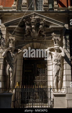 The Atlantes figure by the sculptor H.A. Pegram (1896) at the entrance of Drapers' Hall livery company in Throgmorton Street in the City of London, the capital's financial district aka the Square Mile, on 15th May 2018, in London, UK. The Drapers’ Company is a Livery Company in the City of London whose roots go back to the 13th century, when as its name indicates, it was involved in the drapery trade. While it is no longer involved in the trade, the Company has evolved acquiring a new relevance. Its main role today is to be the trustee of the charitable trusts that have been left in its care o