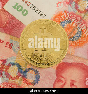 Real bitcoin coin on chinese yuan bills - crypto currency in china concept Stock Photo